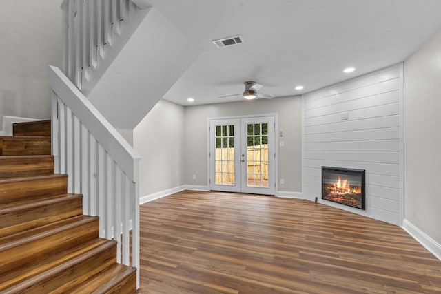 unfurnished living room featuring dark hardwood / wood-style floors, ceiling fan, and french doors