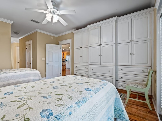 bedroom with ceiling fan, crown molding, wood-type flooring, and white refrigerator with ice dispenser