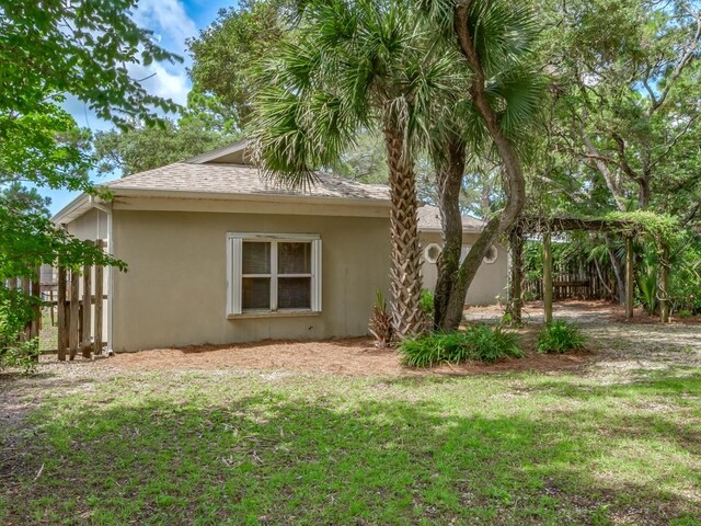 view of side of property featuring a yard