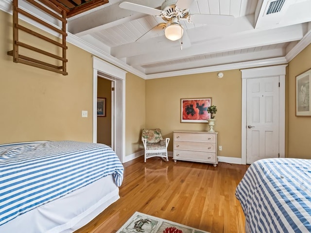 bedroom with beamed ceiling, hardwood / wood-style floors, ceiling fan, and crown molding