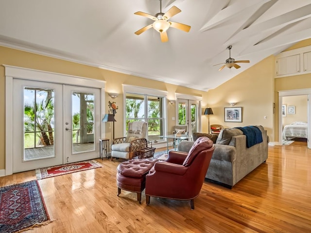 living room featuring french doors, light hardwood / wood-style flooring, vaulted ceiling, and ceiling fan