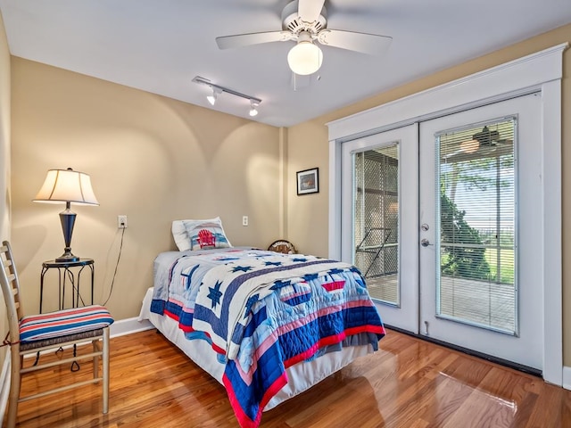 bedroom featuring wood-type flooring, french doors, access to outside, and ceiling fan