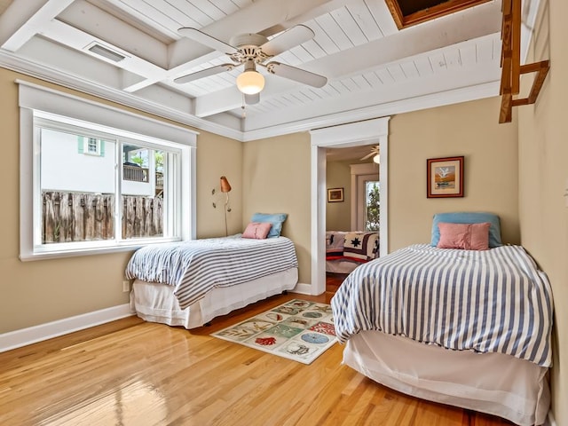 bedroom featuring beamed ceiling, ceiling fan, and wood-type flooring