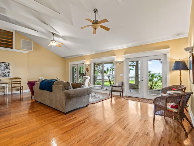 living room with french doors, vaulted ceiling, light hardwood / wood-style flooring, ceiling fan, and ornamental molding