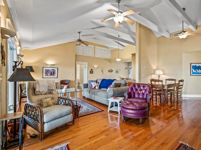 living room featuring vaulted ceiling with beams, hardwood / wood-style flooring, and ceiling fan