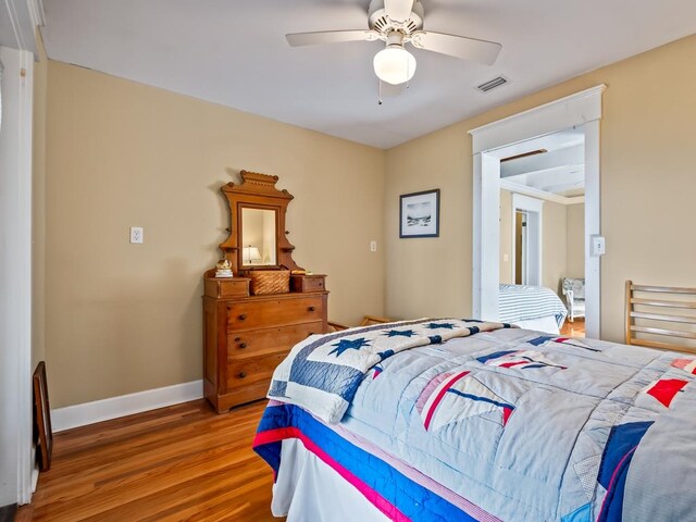 bedroom featuring hardwood / wood-style floors and ceiling fan