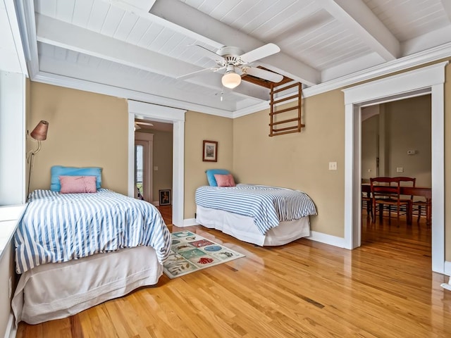 bedroom featuring ceiling fan, hardwood / wood-style floors, beamed ceiling, and wooden ceiling