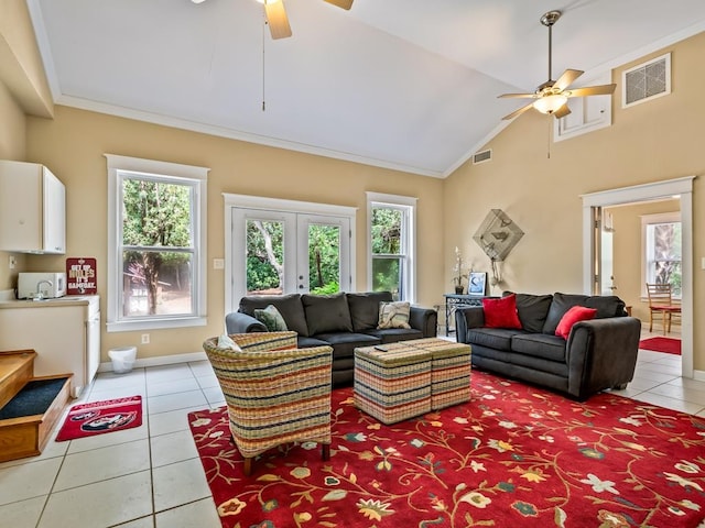 living room with ceiling fan, crown molding, light tile patterned floors, and high vaulted ceiling