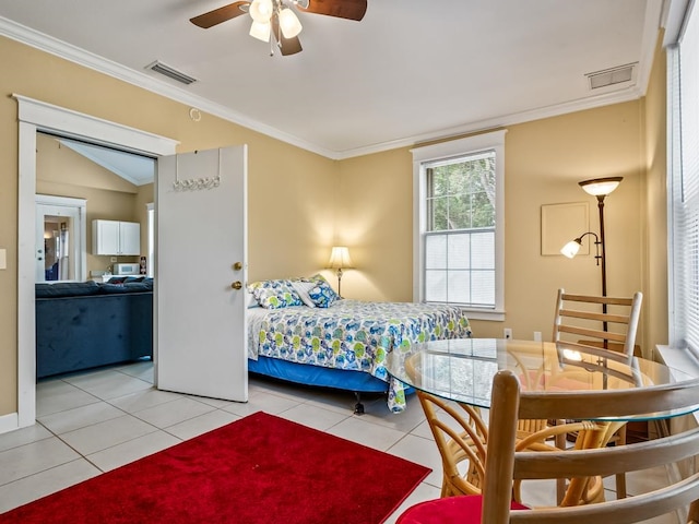 tiled bedroom featuring ceiling fan, ornamental molding, and lofted ceiling