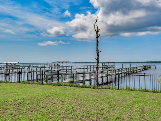 dock area featuring a water view and a yard