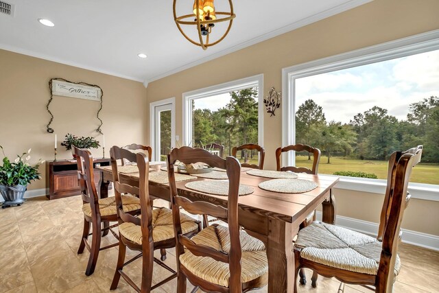 dining area with crown molding and an inviting chandelier