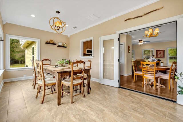 dining room with ceiling fan with notable chandelier and ornamental molding