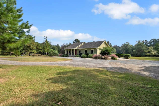 ranch-style home featuring a front yard