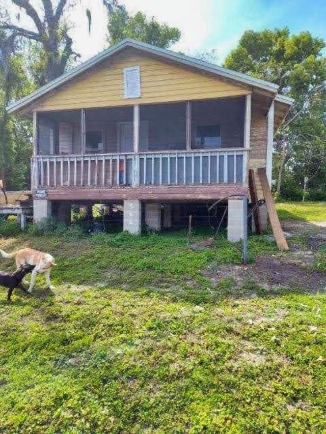 rear view of property with a sunroom