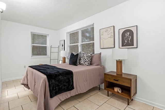 bedroom featuring light tile patterned flooring