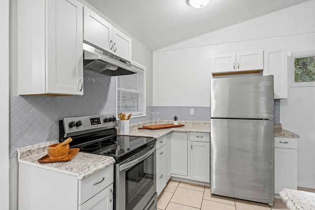 kitchen with white cabinetry, light tile patterned floors, vaulted ceiling, and appliances with stainless steel finishes