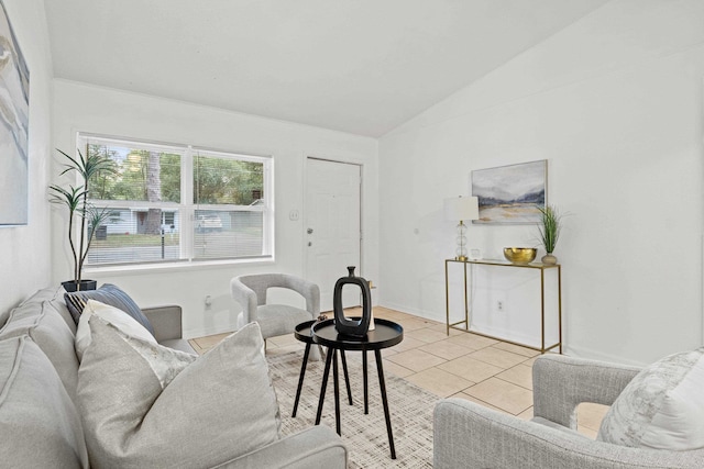 living room with lofted ceiling and light tile patterned floors