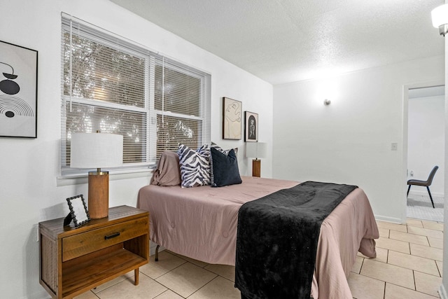 bedroom with light tile patterned floors and a textured ceiling