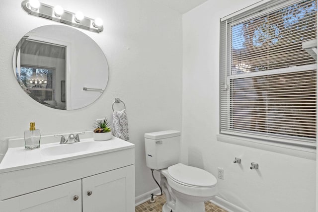 bathroom with tile patterned flooring, vanity, and toilet