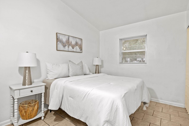 tiled bedroom with vaulted ceiling