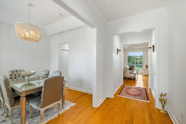 3686 Longfellow Rd, Tallahassee, FL 32311 - dining space featuring a chandelier, light wood-type flooring, crown molding, and baseboards