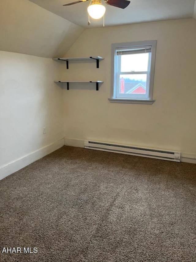 unfurnished room featuring baseboards, a baseboard radiator, ceiling fan, carpet, and vaulted ceiling