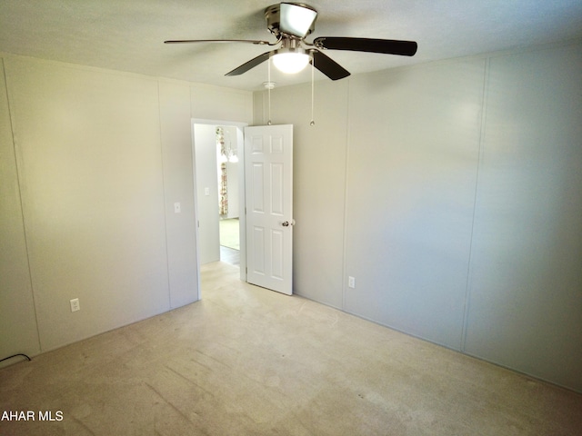 spare room with ceiling fan and light carpet