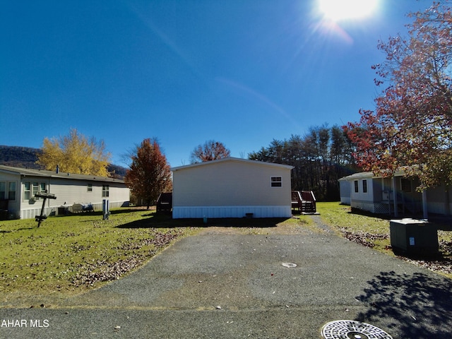 view of property exterior with a lawn