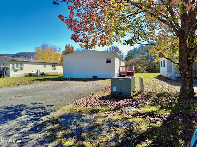 view of home's exterior featuring a wooden deck