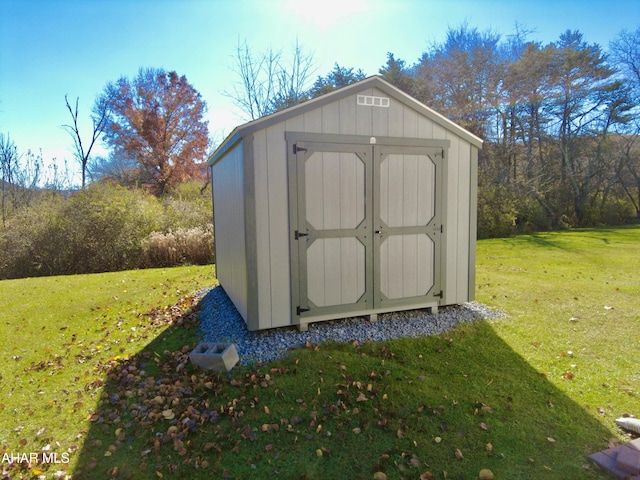 view of outbuilding with a yard