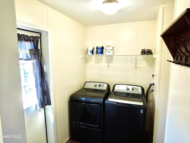 laundry room featuring independent washer and dryer and a textured ceiling