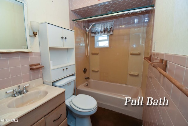 full bathroom with tile walls, vanity, tasteful backsplash, toilet, and tiled shower / bath