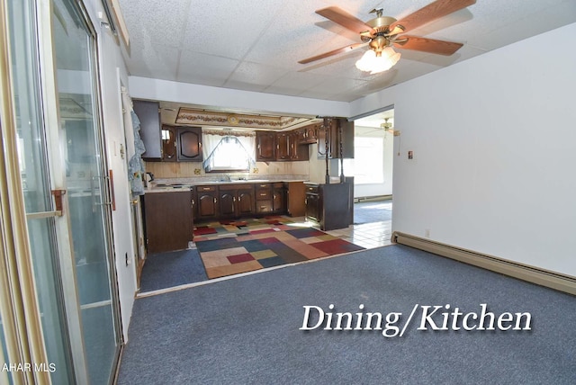 kitchen with dark brown cabinets, a baseboard radiator, and ceiling fan