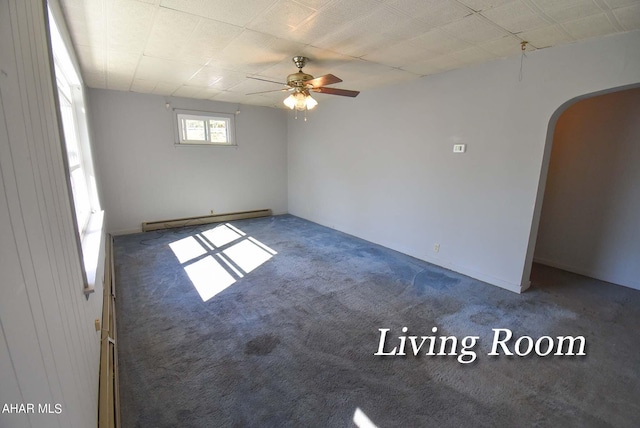 spare room with a baseboard radiator, ceiling fan, and dark carpet