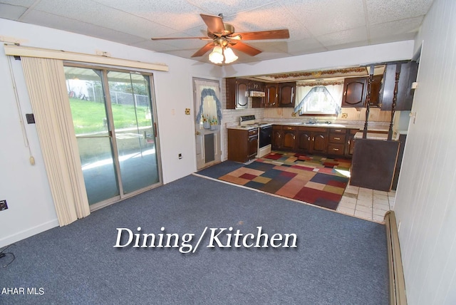 kitchen with dark carpet, dark brown cabinets, white electric stove, and plenty of natural light