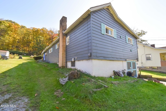 view of side of home featuring a lawn