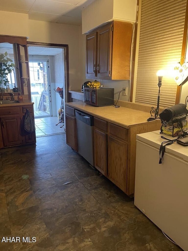 kitchen featuring sink, dishwasher, and refrigerator