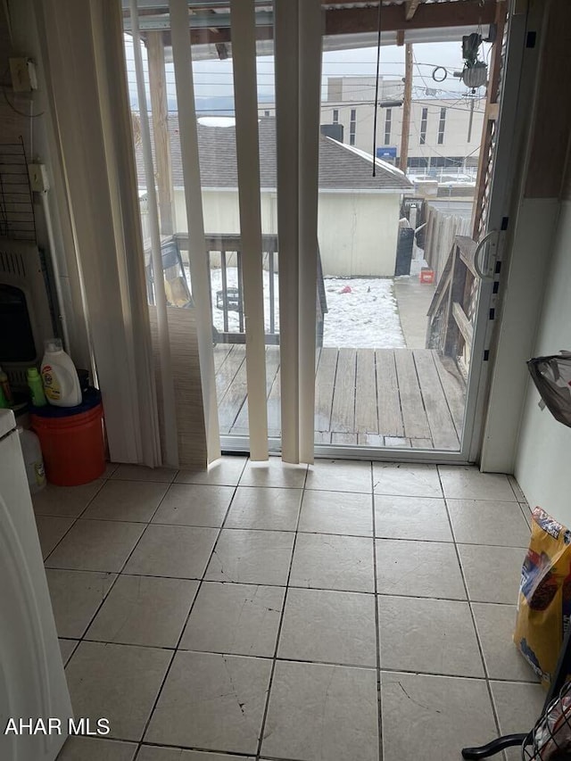 doorway featuring light tile patterned flooring