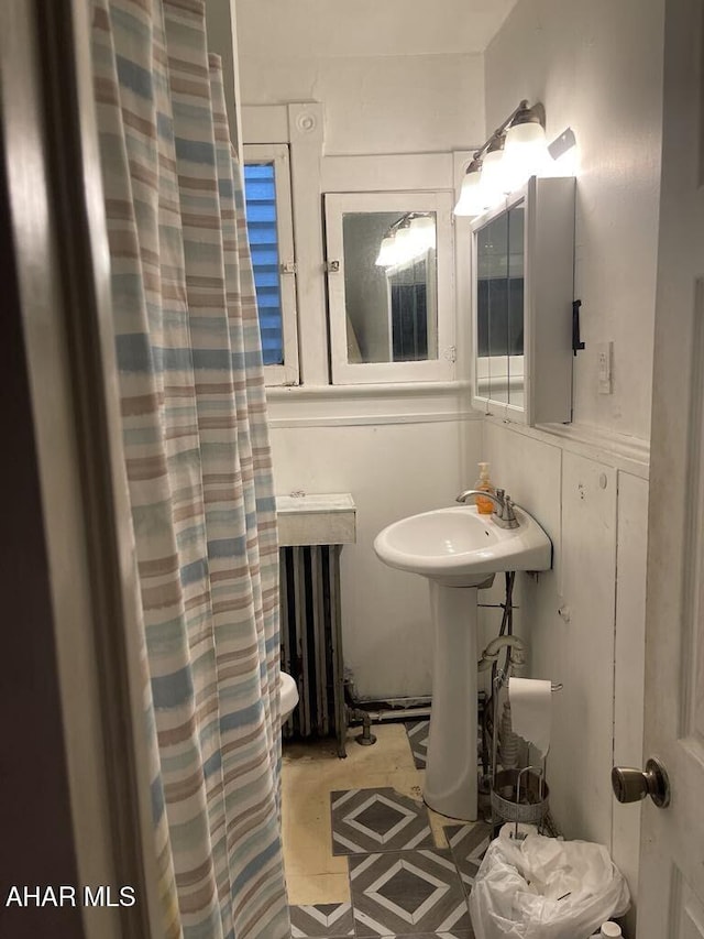 bathroom with sink and radiator