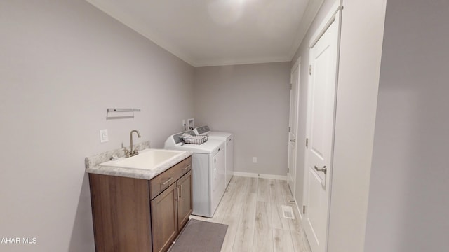 316 Goss Dr, Hollidaysburg, PA 16648 - washroom with washing machine and dryer, cabinet space, light wood-style flooring, and ornamental molding