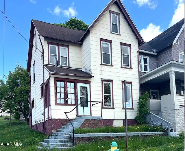 view of front facade featuring roof with shingles