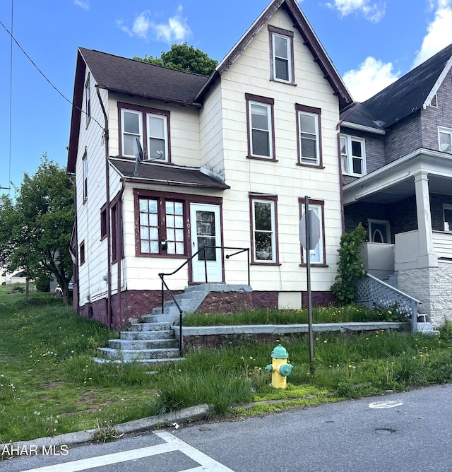 victorian home with roof with shingles