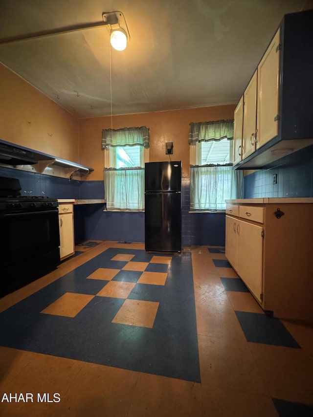 607 N N 8th Ave, Altoona, PA 16601 - kitchen with black appliances, healthy amount of natural light, tile patterned floors, and white cabinetry
