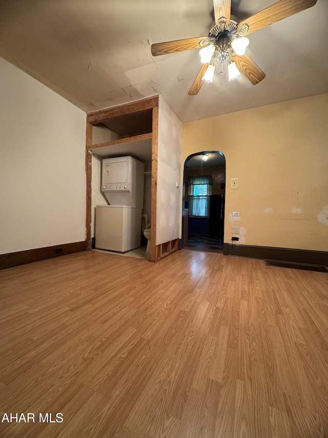 607 N N 8th Ave, Altoona, PA 16601 - unfurnished living room with arched walkways, wood finished floors, and a ceiling fan