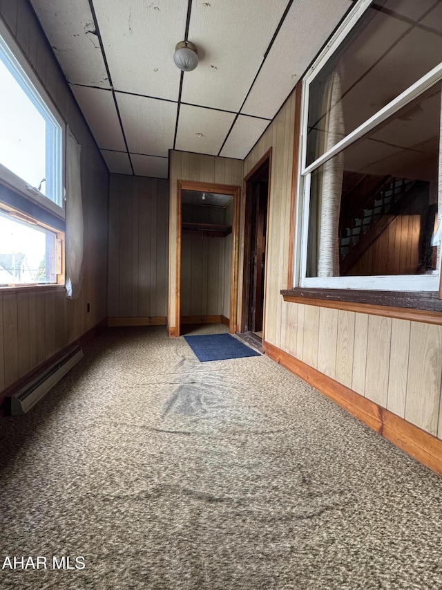 607 N N 8th Ave, Altoona, PA 16601 - carpeted spare room featuring a baseboard heating unit and wood walls