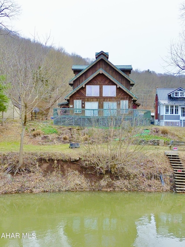 back of property with a water view