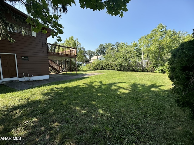 view of yard with a wooden deck