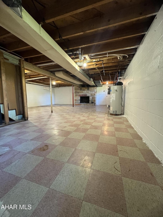 basement featuring a fireplace and water heater