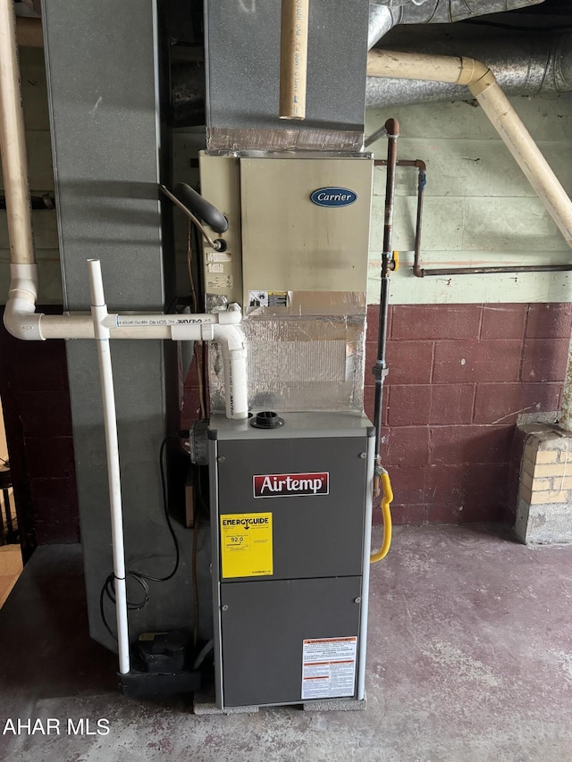 utility room featuring heating unit