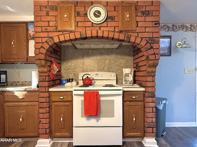 kitchen featuring white range with electric cooktop, dark hardwood / wood-style flooring, and range hood